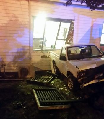 A hole left in a Dunedin house after a hatchback hit a parked ute, shunting it through the wall...