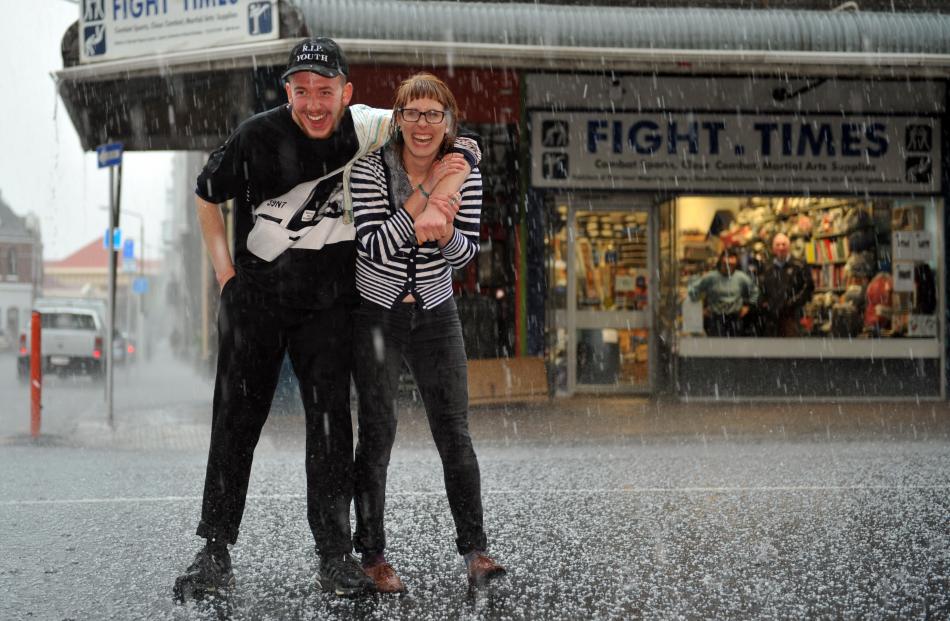  Aidan Geraghty and Emma Payton, both of Dunedin, play in the hail on lower Stuart St. PHOTOS:...