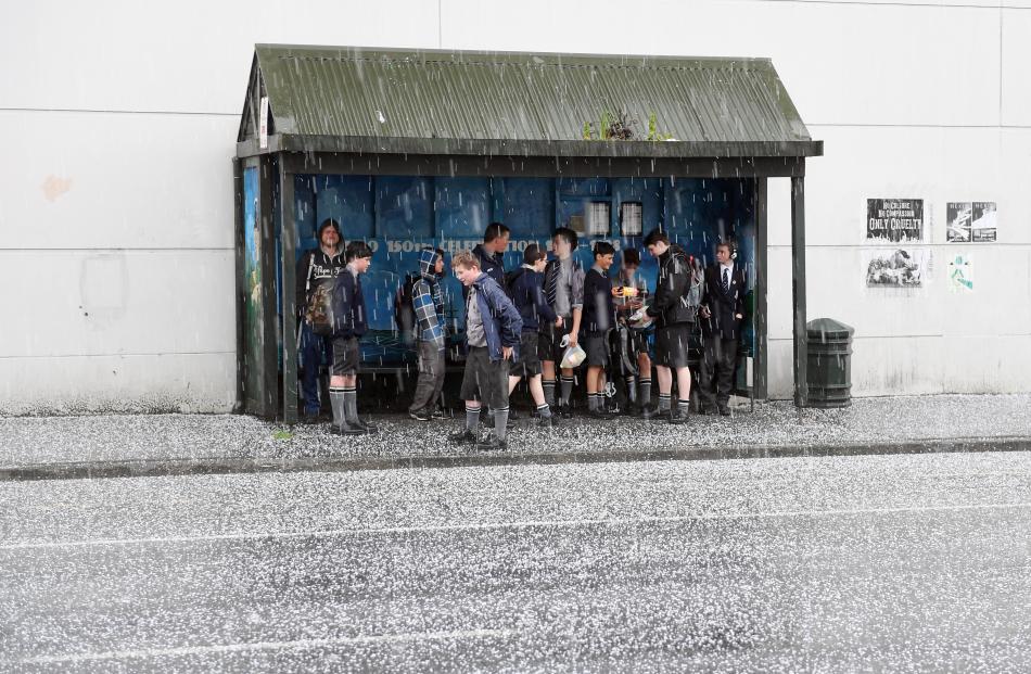  People gather in a bus stop in Cumberland St during an unexpected hail storm