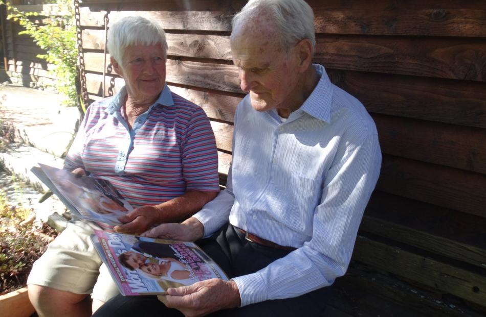 The Blennerhassetts in the sun outside their Barn Pinch home flicking through the pictures of the...