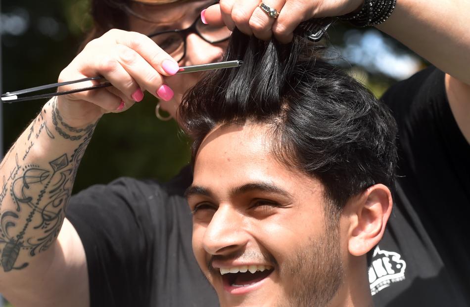 University of Otago second year student Ajay Kumar gets a free trim from Keri O’Connor.
...