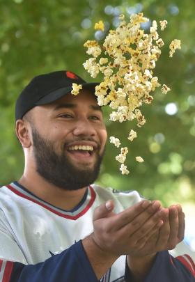 University of Otago third year student Sam Leota (21) throws popcorn.







