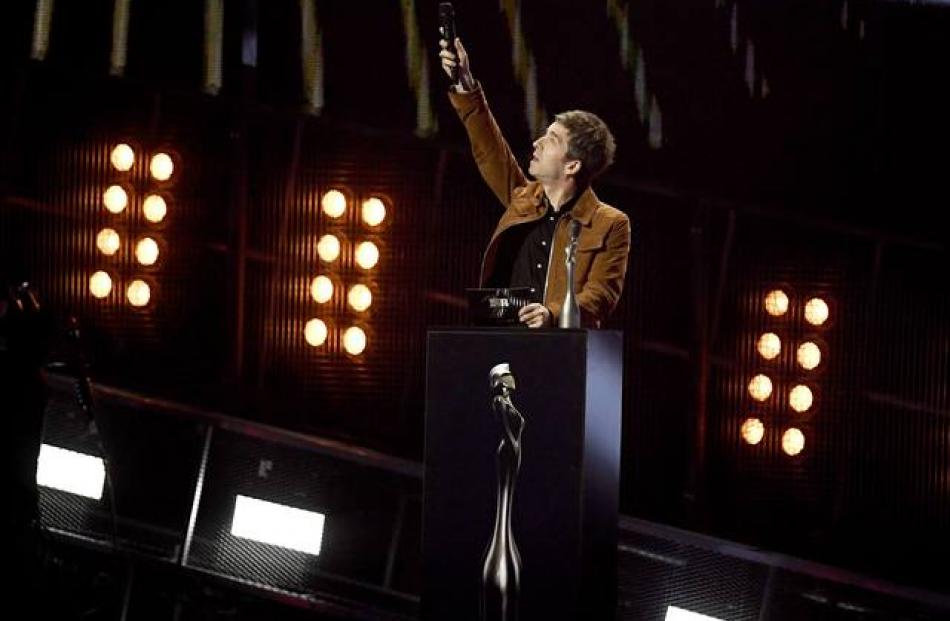 Noel Gallagher gestures as presents Brit Award for British Album of the Year to David Bowie's "Blackstar". Photo: Reuters