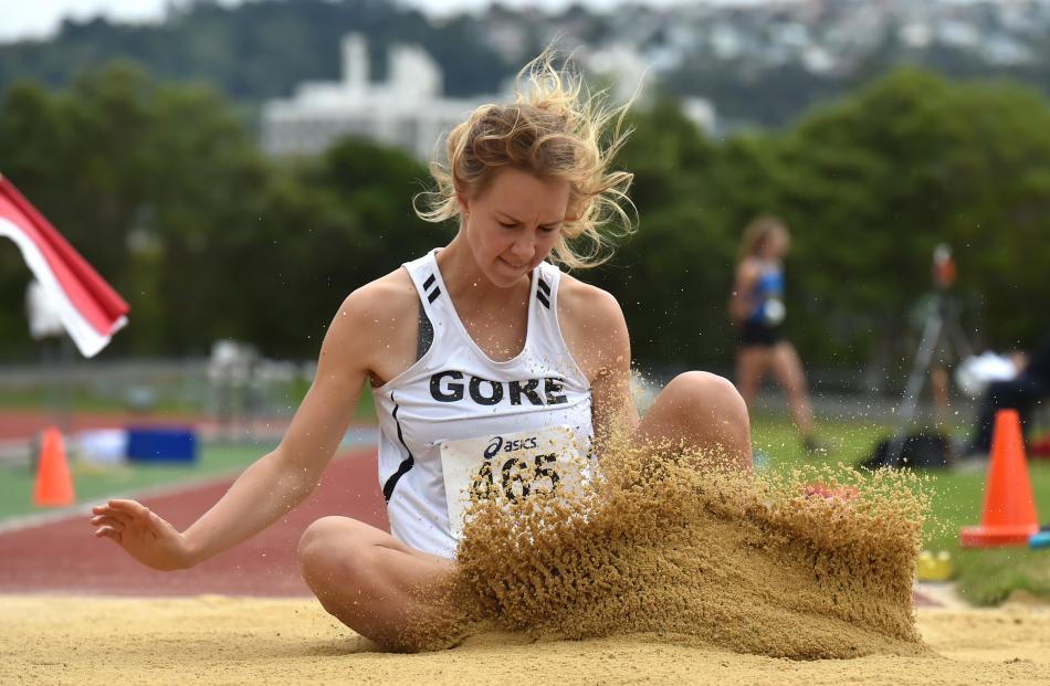  Emma Hopcroft, of Gore, lands during the women’s under-20 long jump.  Photos: Gregor Richardson.