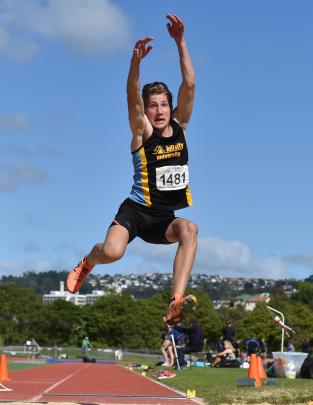 Hill City-University’s Liam Condliffe (16) takes flight in the long jump at the Otago athletics...