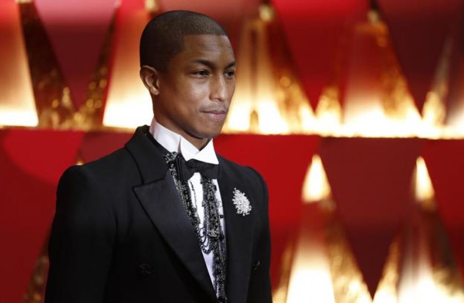 Pharrell Williams, decked out in a fitted Chanel tux accessorized with a dramatic black bead necklace. Photo: Reuters