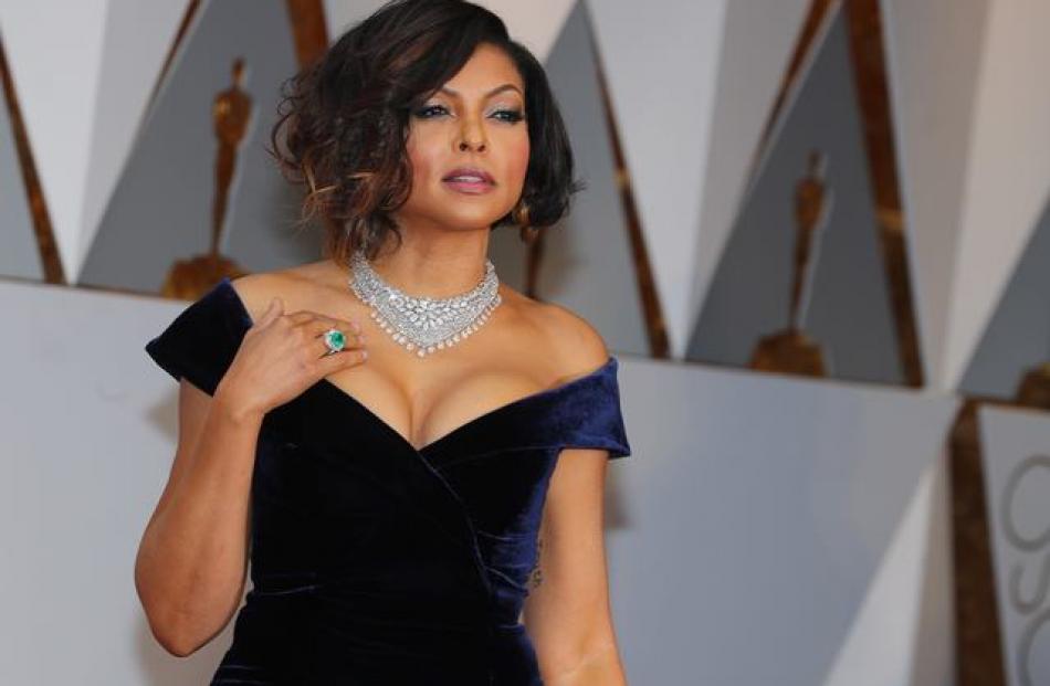 Hidden Figures star Taraji P. Henson poured into a cleavage-bearing midnight blue Alberta Ferretti gown with a daring split at the leg. Photo: Reuters