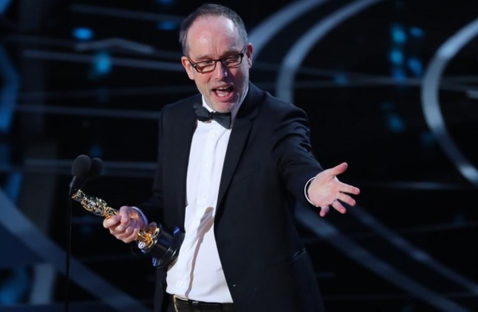 Kiwi John Gilbert accepts the Oscar for Best Film Editing for "Hacksaw Ridge". Photo: Reuters