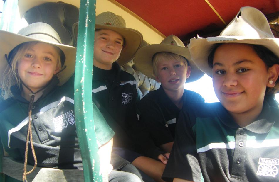 Tarras School children (from left) Aster Stroud (6), Jake O’Sullivan (9), Dart Watson (12) and Dakota Greaves (10) enjoy a stagecoach ride.