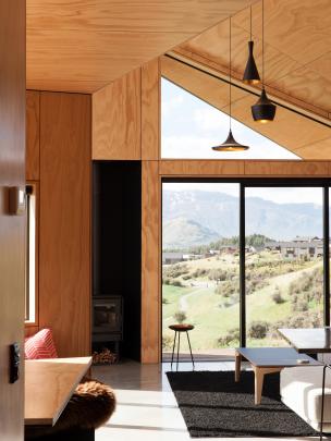 The asymmetrical roof slopes down to follow the contour of the land, giving a dynamic feel to the...