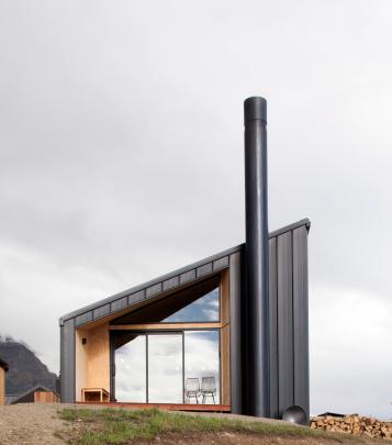 The form of the house is inspired by the rural shed but the asymmetrical gable creates dynamic...