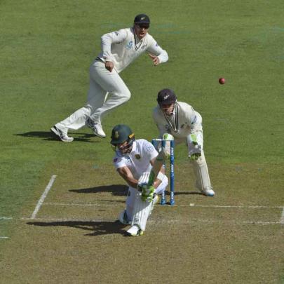 Du Plessis plays a sweep shot as Watling and Ross Taylor look on.