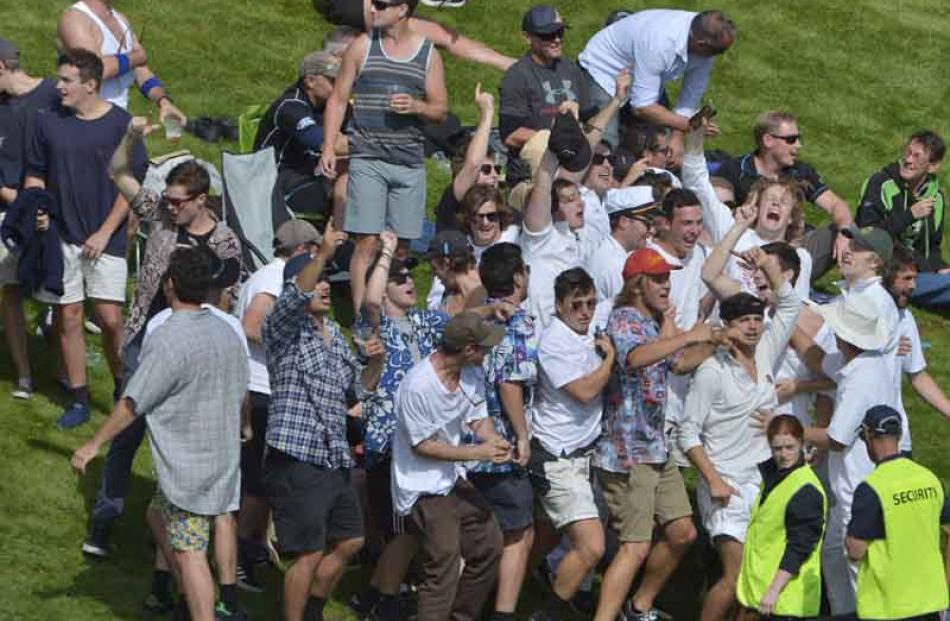 A vocal section of the crowd at the University Oval yesterday.