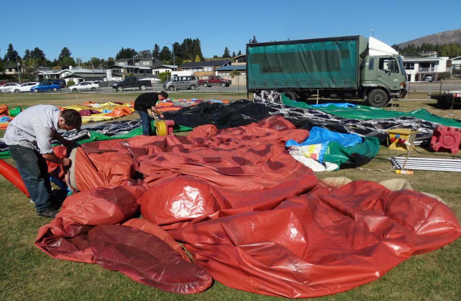 Inflating the King Kong and dinosaur slide for the Wanaka A&P Show are Max Campbell (left), of Dunedin, and Ramene Fisher, of Invercargill. Photos by Kerrie Waterworth.
