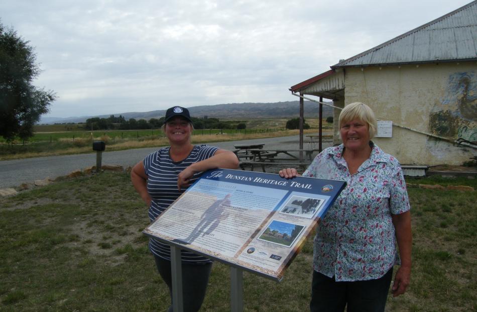 Sarah (left) and Sue Falconer stand beside a Promote Dunstan heritage sign recently installed at...