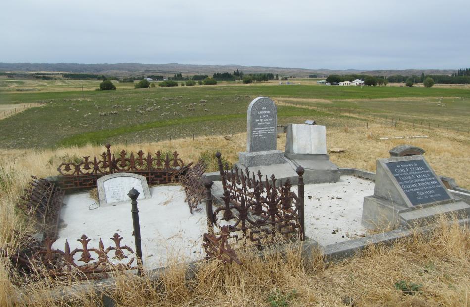 Headstones and fenced surrounds (left) mark gravesites at the Ida Valley-Moa Creek cemetery. A...