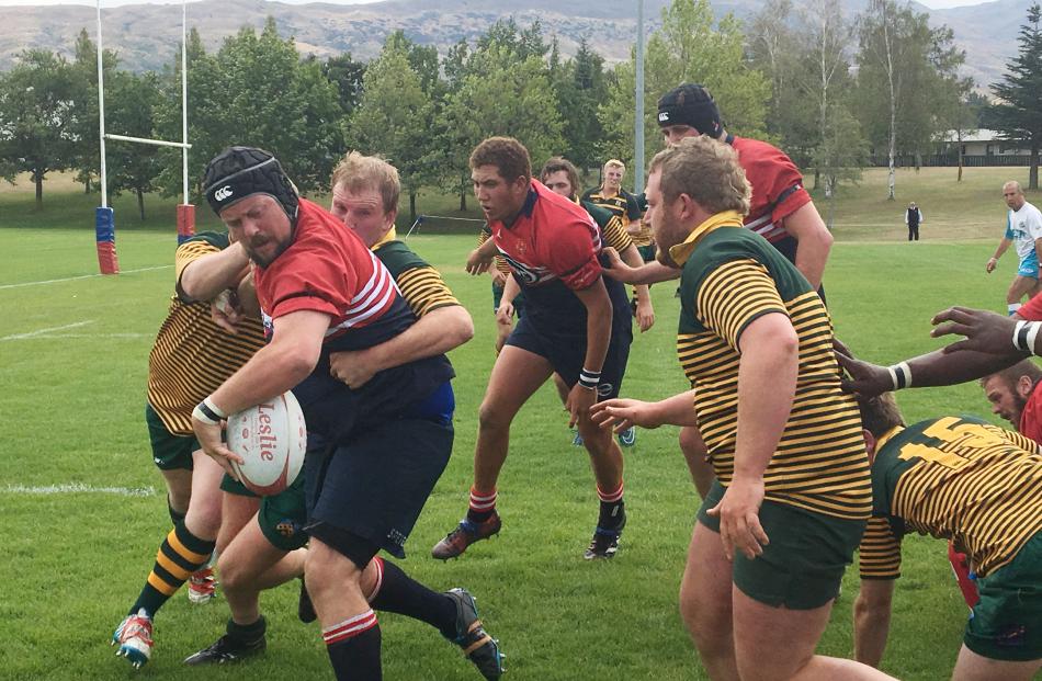 Cromwell Rugby Club premier team member Mike O’Driscoll fends off Eastern players during the Andrew Grubb Memorial Game.