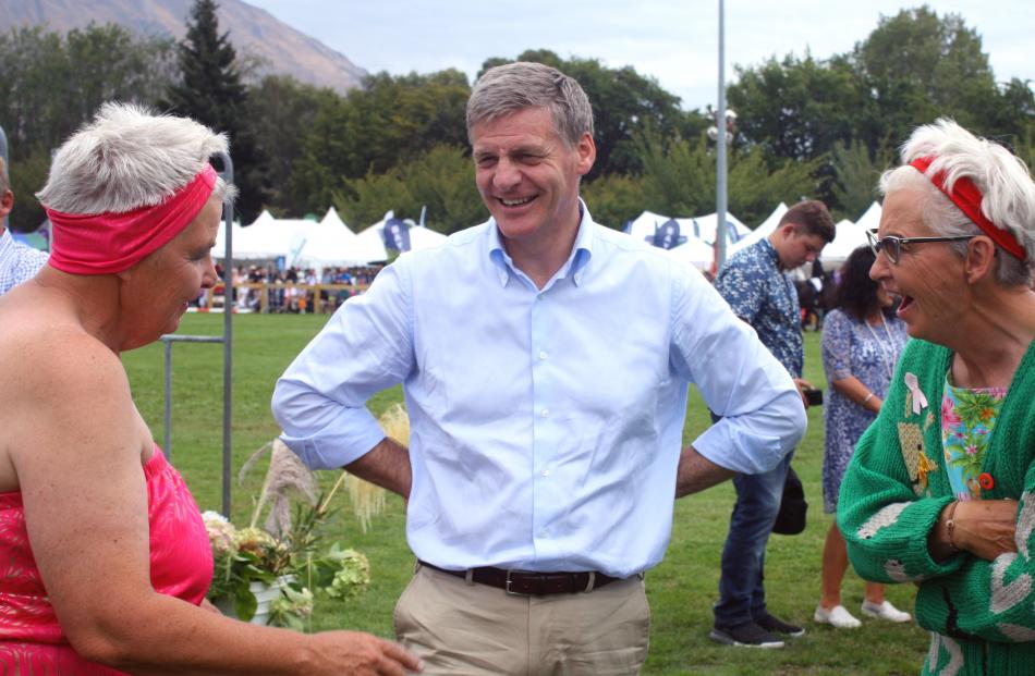 Prime Minister Bill English shares a joke with Topp Twins Lynda (left) and Jools, during the Wanaka A&P Show's grand parade. 