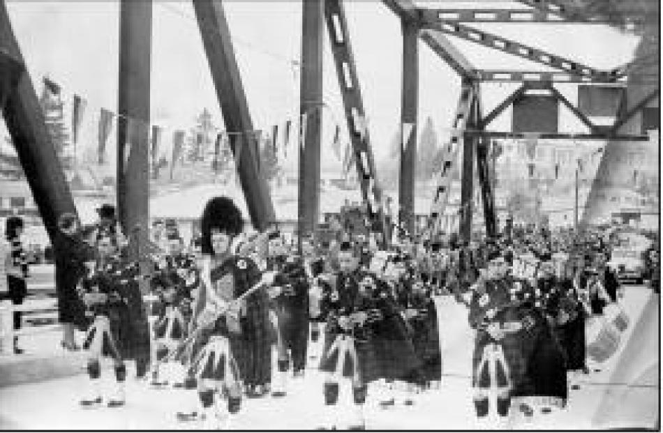The big day: The Alexandra Pipe Band leads the procession for the opening of the Alexandra Bridge...