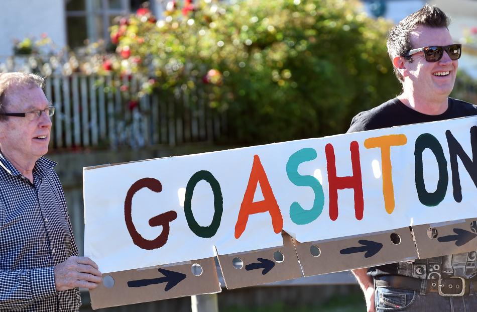 Brian Nicholls and Gavin Nicholls hold a sign in support of Ashton Hollamby during the cycle leg.