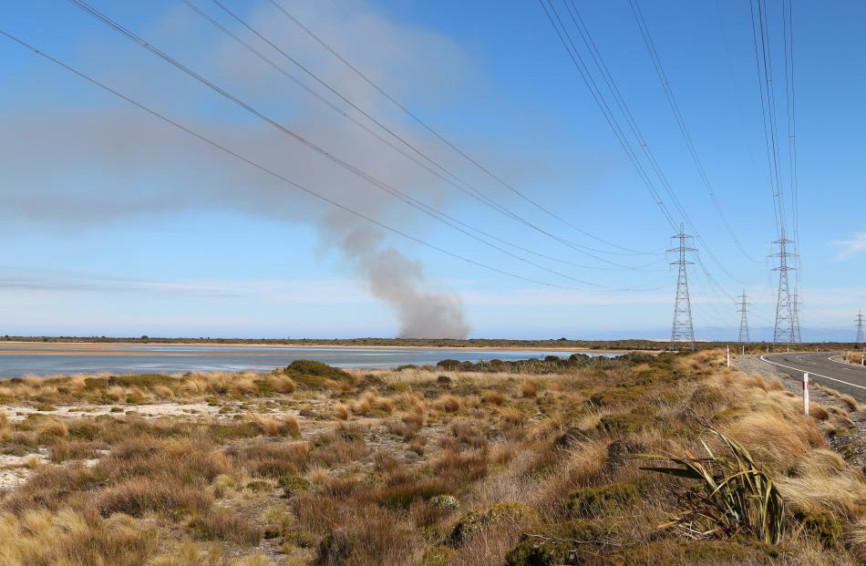 Smoke rises from a scrub fire at Tiwai Point, in Southland. Photo: Shane Rhodes