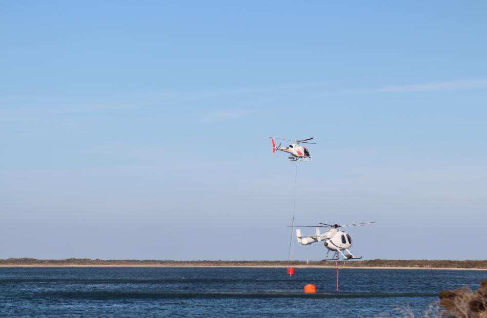 Three helicopters with monsoon buckets helped to bring the fire under control about 4pm. Photo: Shane Rhodes