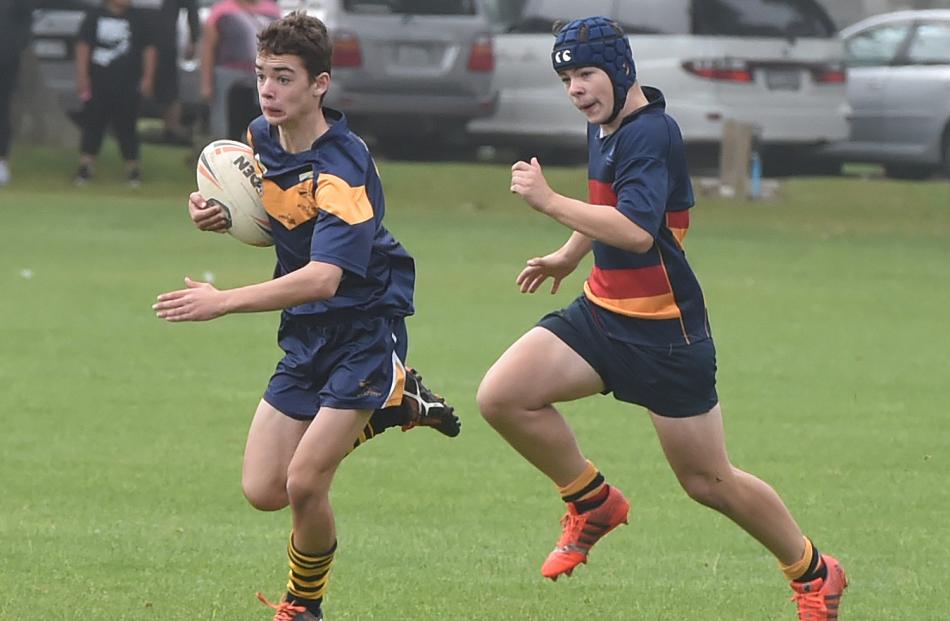 Sam Teal, of the Central Otago Mustangs, is chased by Adam Woodhouse, of John McGlashan College.