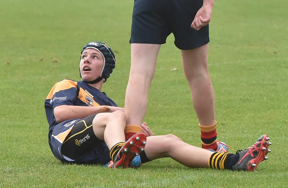 Sam McLean, of the Central Otago Mustangs team, looks up to the referee to see if his try is...