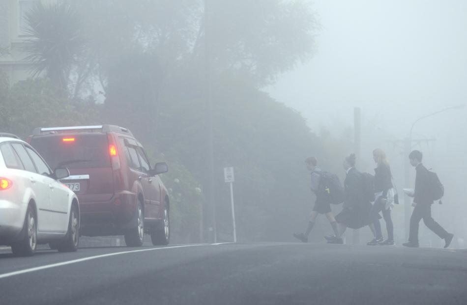Pupils cross Highgate on their way to school yesterday morning.