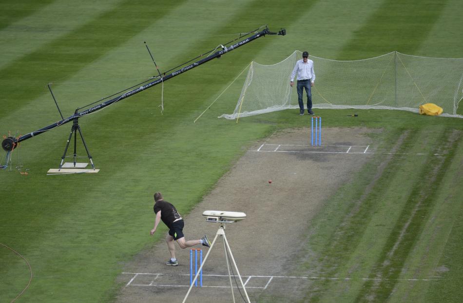 MIT consultant Jaco Pretorious (left) bowls a ball while testing systems at the University Oval...