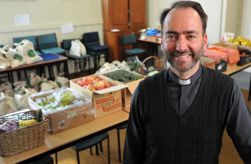 The Rev Michael Wallace relaxs after packing fruit and vegetables into bags for the All Saints’ fruit and veges co-operative scheme. Photos by Christine O'Connor.