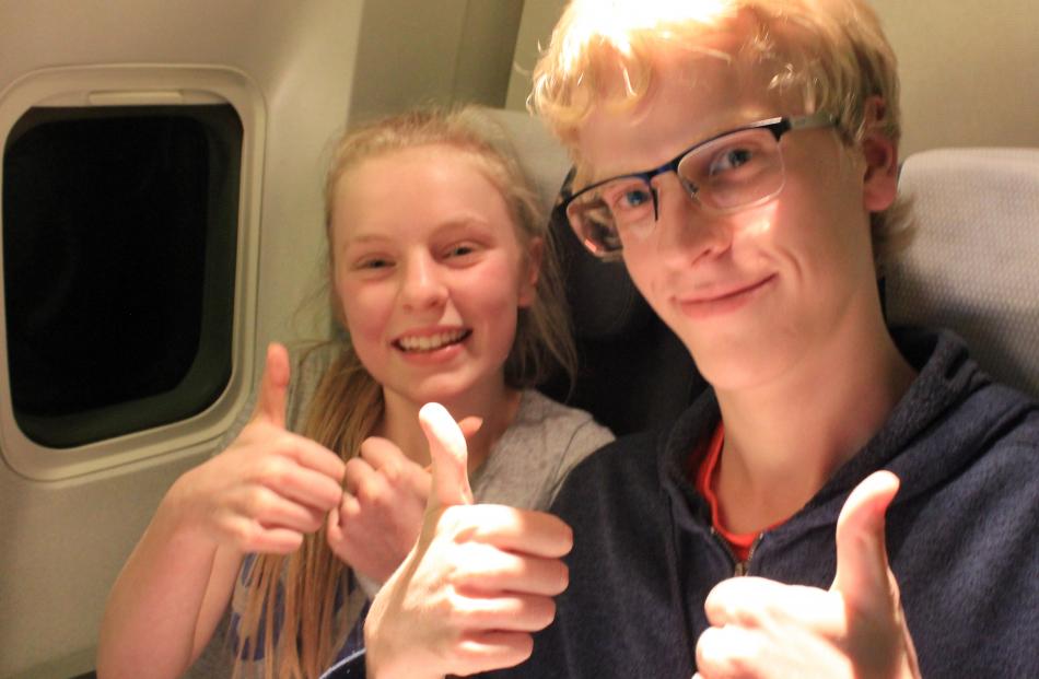 Harriet (14, left) and Elliot (18, right) Cottle, of Dunedin, on board flight NZ1980, bound for...