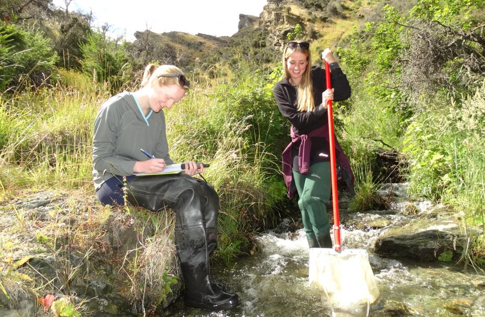 Bryony Alden and Skye Anderson in a tributary of the Shotover River on Coronet Peak Station. 