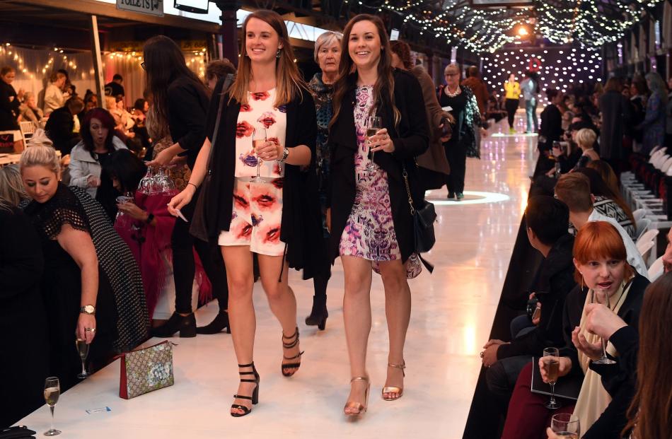Ellyn Robertson (left) and Louise Anderson, both of Dunedin, head down the catwalk to their seats.