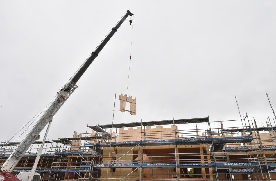  A mobile crane with a 70-tonne lifting capacity lifts a two and a-half tonne prefabricated wooden wall panel into position at the  Otago Polytechnic student village project.PHOTO: GREGOR RICHARDSON