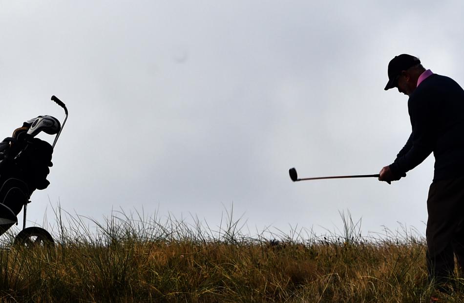 Peter Robson, of Brisbane, plays a chip shot on the ninth hole during the national left-handed...