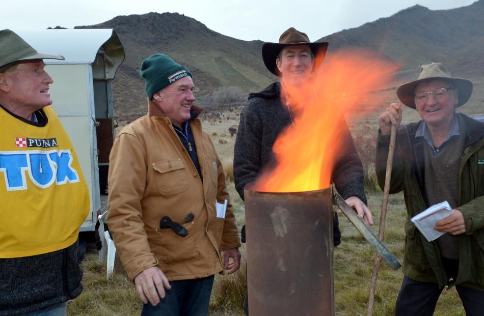 Keeping warm at last year's South Island and New Zealand sheep dog trial championships at Omarama are (from left) Brian Dickison (Waikaka), Paul McCarthy (Alexandra), Rod Coulter (Winton) and Steve Vickers (Palmerston).