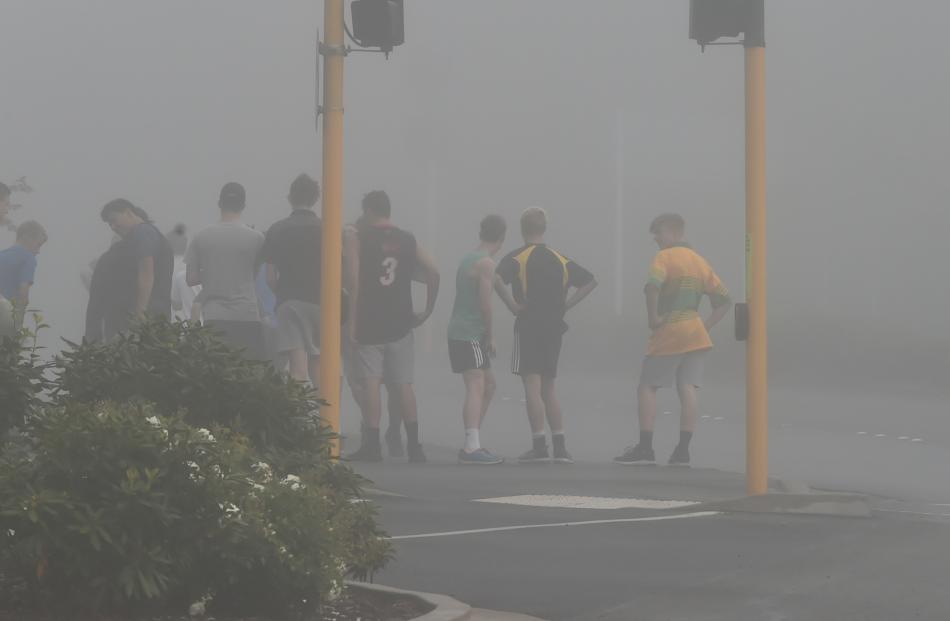 Otago Boys' pupils brave the foggy Dunedin morning on Staurt St. PHOTO: Gregor Richardson