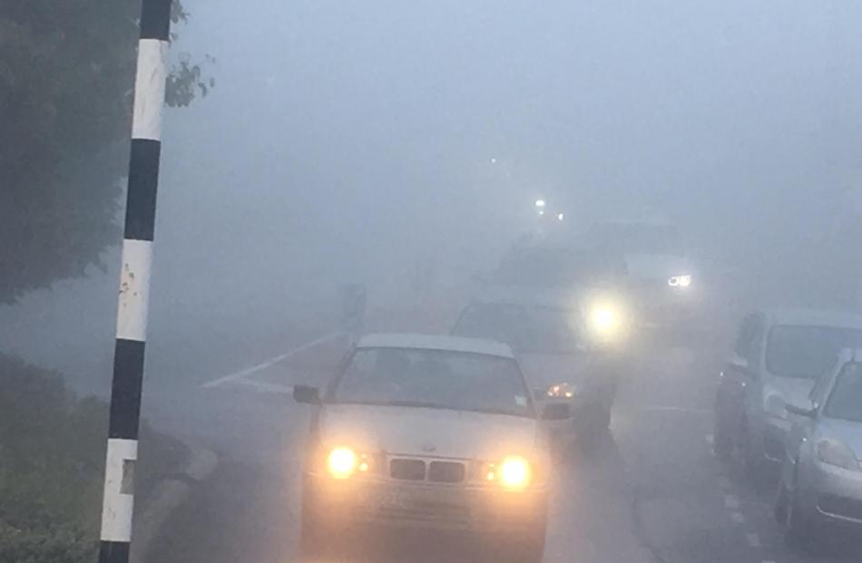 Motorists contend with thick fog on Highgate in Dunedin this morning. Photo Stephen Jaquiery