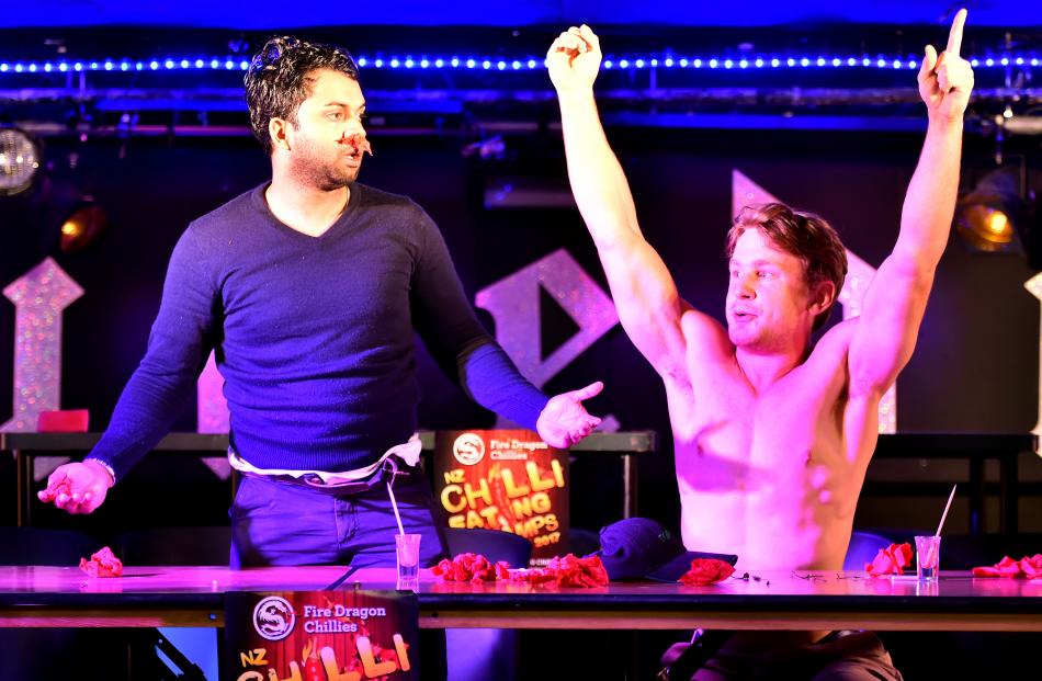 Dr Venod Skantha (left), of Dunedin, admits defeat to University of Otago student Harrison Walmsley-Bartlett, of Hastings, at the Dunedin heats of the New Zealand Chilli Eating Champs at Re:Fuel Cafe and Bar last night. Photo by Gregor Richardson..