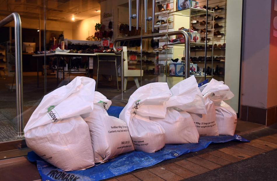 Shop doors sand bagged in South Dunedin. Photo: Stephen Jaquiery