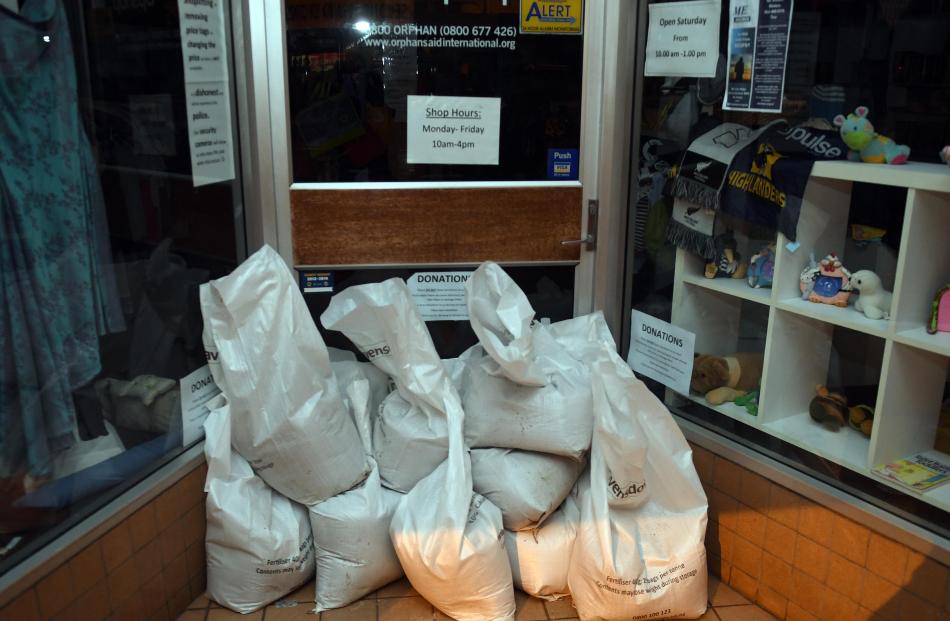 Shop doors sand bagged in South Dunedin. Photo: Stephen Jaquiery