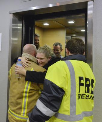When the doors are finally opened, a relieved Ms Shepherd hugs station officer Brent Key.