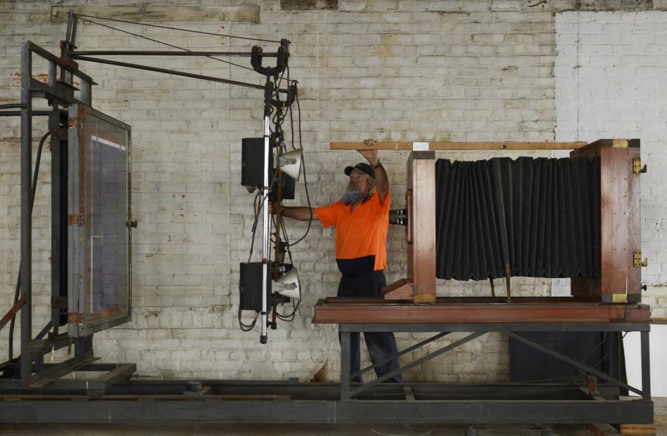 Zeal Steel's Alan Bryan examines a vintage Lithotex camera at the John Colours Building in Crawford St. Photos by Gerard O'Brien.Manufacturer and distributor tags attached to the camera.