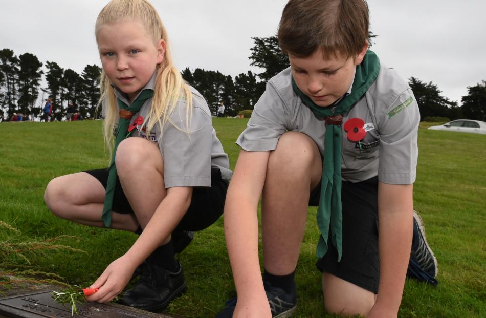 Green Island Scouts Alice Barrett (11) and Jonathan Tucker (10) lay posies of rosemary on the veterans graves at Green Park Cemetery, near Waldronville. Photo: Gregor Richardson.