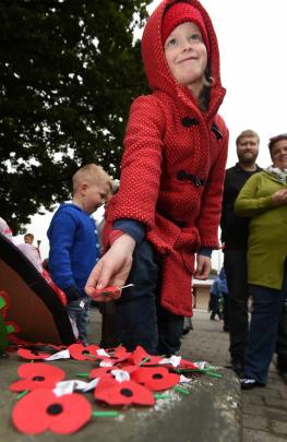 Gabby McGowan (7), of Mosgiel, lays a poppy at the foot of the Mosgiel cenotaph. Photo: Gregor Richardson.