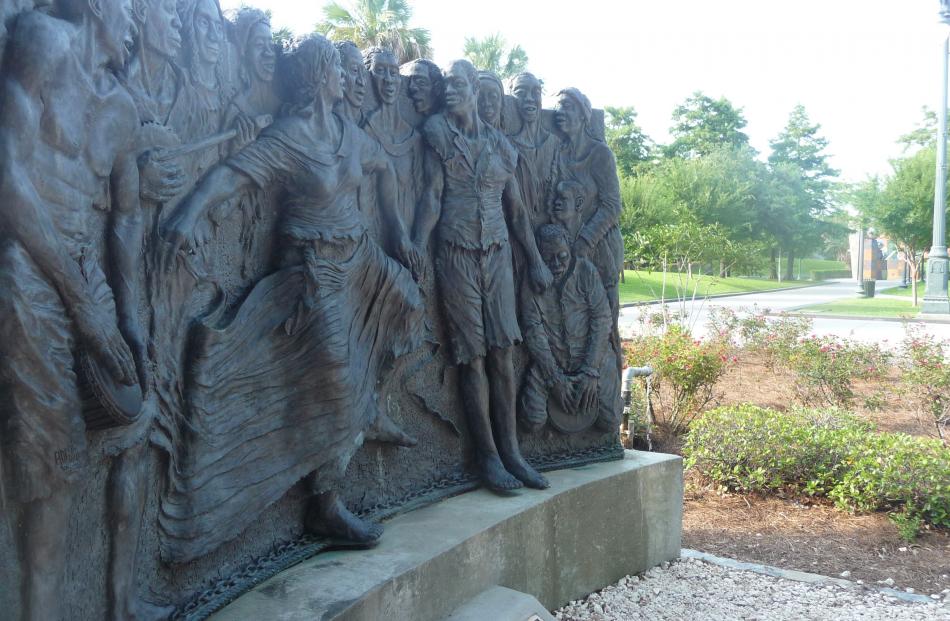 A sculpture is dedicated to Congo Square, where slaves used to gather to play music one day a...