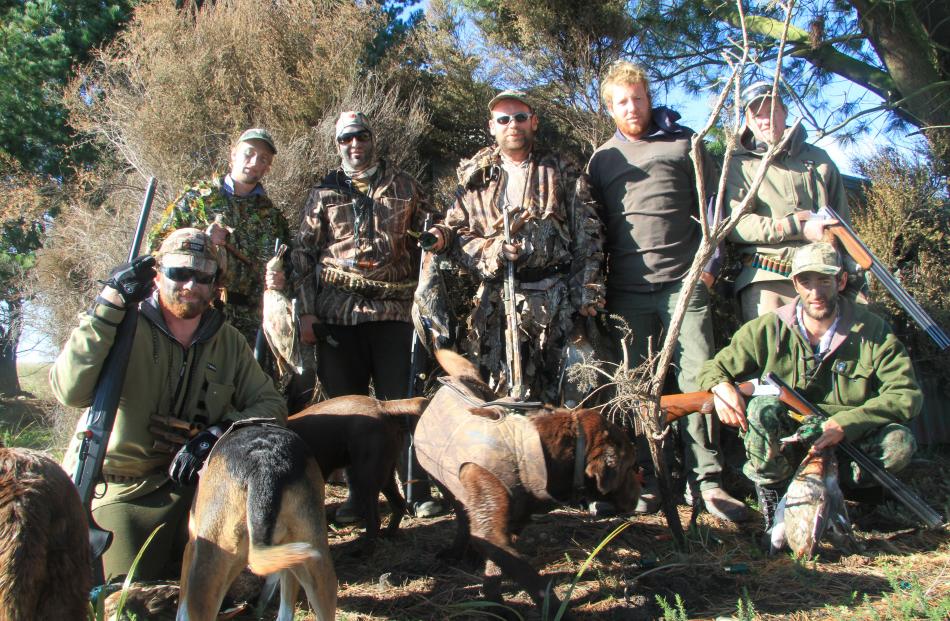 At a Glenavy pond on Saturday (from left) Allon Wood, Brendan Morris, Cam Kyle, Andrew Fuller, James Tait, James Bee and Richie Ford take a break after killing about 40 ducks by 11am. Photo: Hamish MacLean.