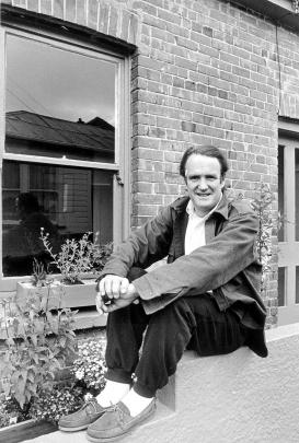 Playwright Robert Lord outside his cottage in Titan St about 1990.