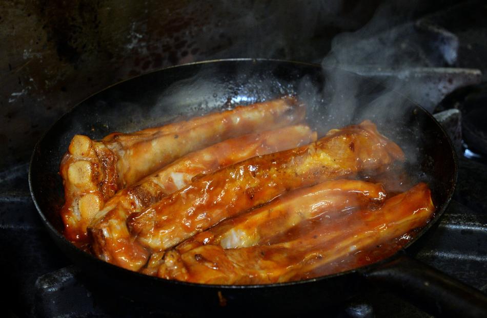 Cooking the spare ribs in a glaze.